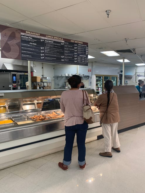 Customers visit the deli section on July 21 inside the new Bashas' Diné Market in Shiprock. The grocery store location had been operated by City Market since 1986 and Bashas' Family of Stores acquired it within the last year.