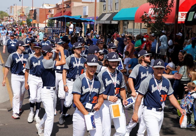The Albuquerque Baseball Academy team walk the route of the 2021 Connie Mack World Series parade on July 22 in downtown Farmington.