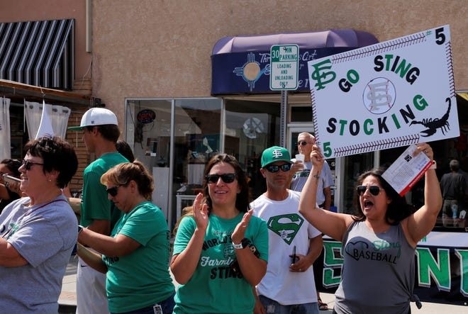 Supporters of the Farmington Sting cheer on the team during the 2021 Connie Mack World Series parade on July 22 in downtown Farmington.