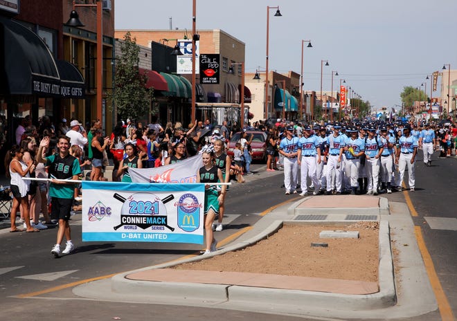 Teams participating in the 2021 Connie Mack World Series receive a welcome from spectators during the series parade on July 22 in downtown Farmington.