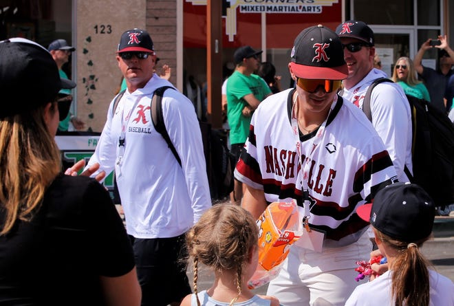 Young spectators at the 2021 Connie Mack World Series parade receive candy from a Nashville Knight player on July 22 in downtown Farmington.