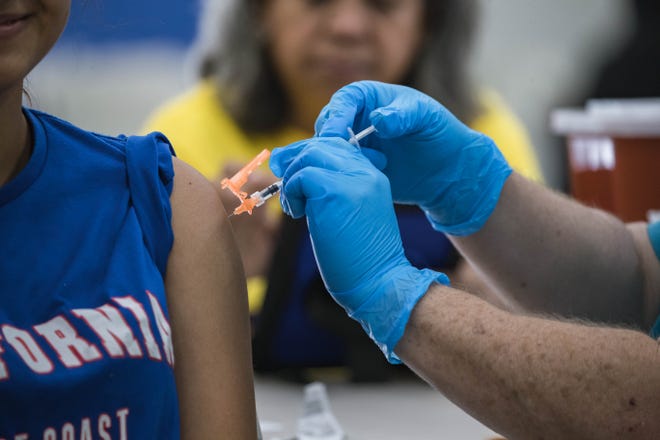 Jasmine Serrano receives a vaccine shot at a vaccination clinic at the Hatch Community Center in Hatch on Saturday, July 24, 2021.
