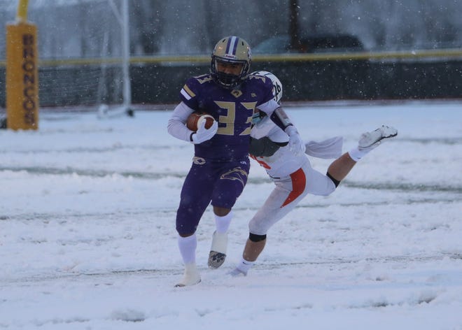 Kirtland Central’s Zakk Thomas fights for extra yards against Aztec’s Hunter Riddick on Saturday, March 13, 2021, at Bill Cawood Field in Kirtland.