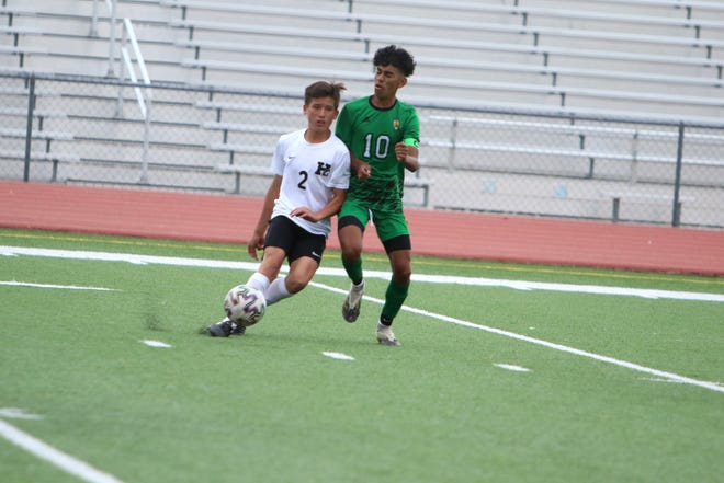 Farmington boys soccer midfielder Jesus Flores, shown here battling for possession with Hope Christian's Bailyn Gasper during a match Saturday, Sept. 17, 2021 at Hutchison Stadium.