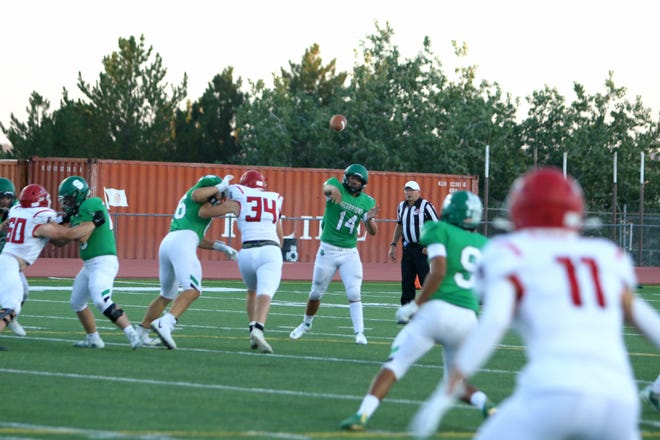 Farmington High quarterback Brandon Furbee throws a pass to wide receiver Ethan Thomas during a game against Durango High, Friday, Sept. 17 at Durango High School.