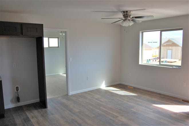 The living room of one of the two homes built by students in the San Juan College building trades program is pictured.
