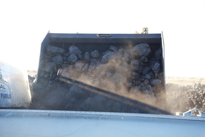 A loader dumps coal into a pickup truck bed on Oct. 13 during the opening day of Community Heating Resource Program at Navajo Mine.