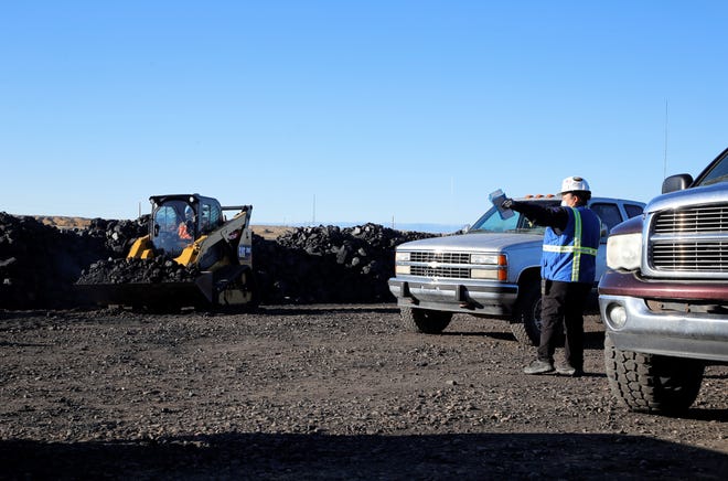 Chapter residents picking up free coal from the Community Heating Resource Program receive directions to park on Oct. 13 at Navajo Mine.