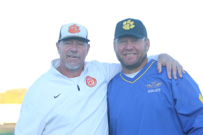 Aztec Tigers football coach Eric Stovall and Bloomfield Bobcats head football coach Mike Kovacs take a moment during pregame warmups at Fred Cook Memorial Stadium, Friday, Oct. 15, 2021.