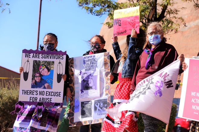 Posters call attention to domestic violence on the Navajo Nation during an awareness walk on Oct. 18 in Window Rock, Arizona.