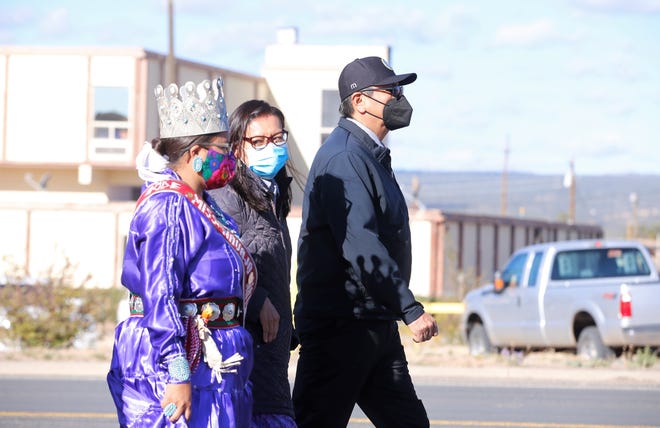 From left, Miss Navajo Nation 2021-2022 Niagara Rockbridge, Navajo Nation first lady Phefelia Nez and President Jonathan Nez participate in an awareness walk for domestic violence on Oct. 18 in Window Rock, Arizona.