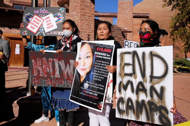 Posters call attention to cases of missing and murdered Diné women and girls during the Diné Sáanii for Justice march on Oct. 18 in Window Rock, Arizona.