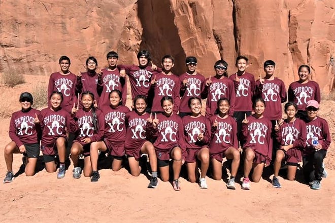 The Shiprock boys and girls cross country teams pose for a photo after winning the District 1-4A championship meet at Church Rock, Saturday, Oct. 30, 2021.