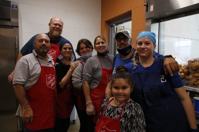 The volunteer kitchen crew at the Salvation Army's annual Thanksgiving luncheon pause services for a photo on Nov. 25 at Sycamore Park Community Center in Farmington.