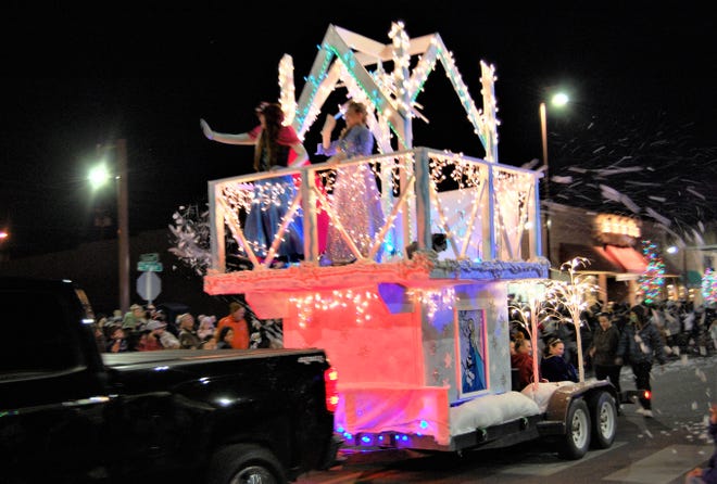 A float spraying fake snow is towed down Main Street through downtown Farmington on Dec. 2 during the annual Christmas Parade.