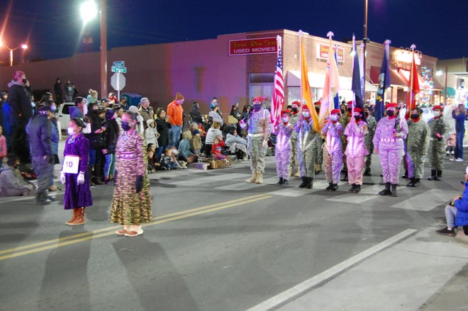 A color guard unit marches at the head of the Christmas Parade through downtown Farmington on Dec. 2.