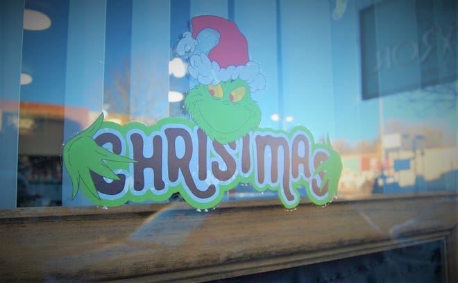 A downtown Aztec business features a Grinch decal as part of the "Find the Grinch" contest continuing through Dec. 11.