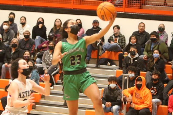 Farmington High School's Kiiyani Anitielu drives to the basket during a game against Aztec High School, Tuesday, Dec. 21, 2021 at Lillywhite Gym