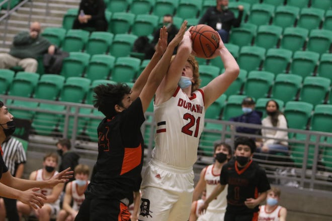 Durango High School's Jacob Neubert goes up for a jump shot against Gallup's Kristian Touchine during their first game of the Marv Sanders Invitational Tournament, Thursday, Dec. 16 in the Scorpion Arena at Farmington High School.