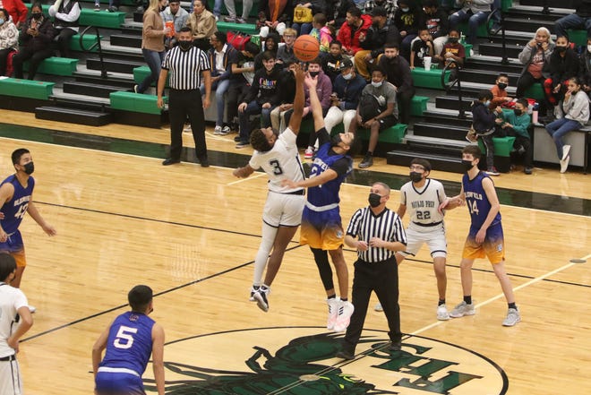 Bloomfield High School's Jeremiah Sandoval and Navajo Prep's Dontrelle Denetso go up for the opening tip of their first game of the Marv Sanders Invitational Tournament, Thursday, Dec. 16 in the Scorpion Arena at Farmington High School.