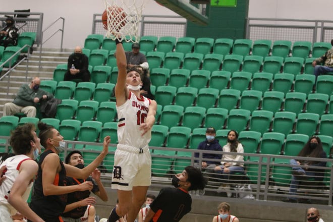 Durango High School's Jasper Zastrocky goes for a layup over a trio of Gallup defenders during their first game of the Marv Sanders Invitational Tournament, Thursday, Dec. 16 in the Scorpion Arena at Farmington High School.