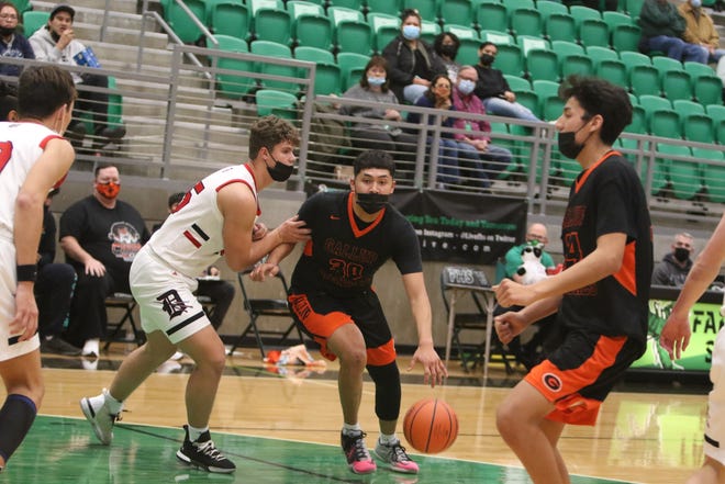 Gallup High School's Joaquin Ortega looks for an opening around Durango's Tyler Harms during their first game of the Marv Sanders Invitational Tournament, Thursday, Dec. 16, 2021 in the Scorpion Arena at Farmington High School.