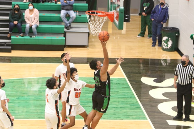 Farmington High School's Trel Griego gets behind a trio of Gallup defenders on his way to the basket during their third round game of the Marv Sanders Invitational Tournament, Saturday, Dec. 18, 2021 in the Scorpion Arena at Farmington High School.