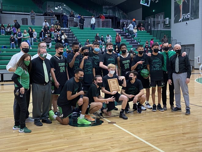 The Farmington High boys basketball team poses for photos after winning the Marv Sanders Invitational Tournament at Farmington High School.
