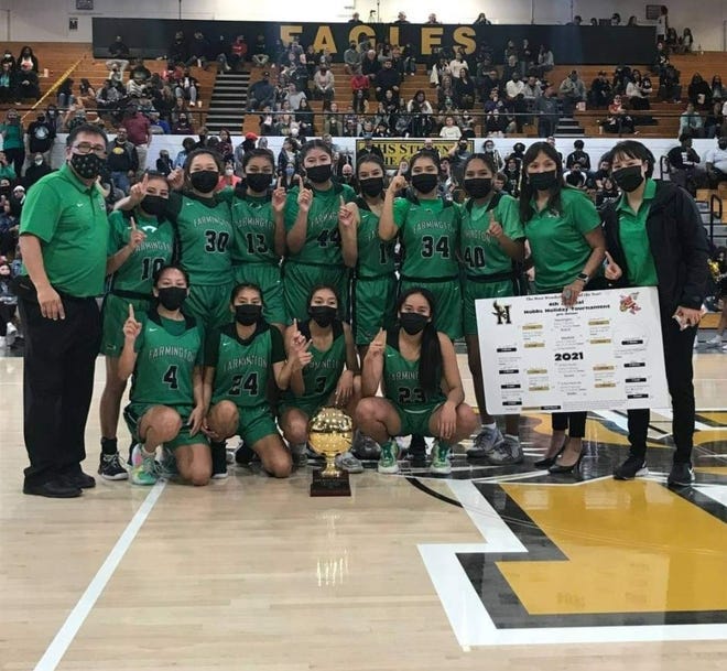 The Farmington Scorpions girls basketball team poses with the championship trophy after winning the Hobbs Holiday Tournament, Wednesday, Dec. 29, 2021 at Hobbs High School.