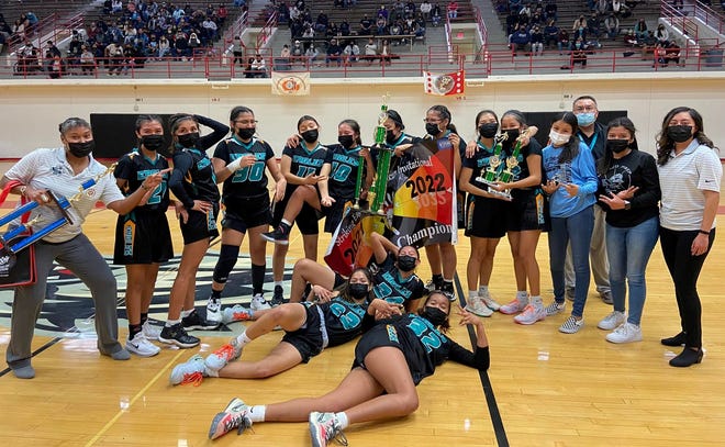 The Navajo Prep girls basketball team poses with the championship trophy after winning the Striking Eagle Native American Invitational, Thursday, Dec. 30, 2021 in the Johnson Center at the University of New Mexico.