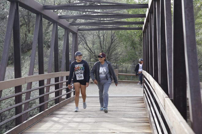 Participants walk part of the 1.4-mile course for Just Move It on May 11 at Berg Park in Farmington.