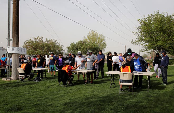 Participants check in to start Just Move It on May 11 at Berg Park in Farmington.