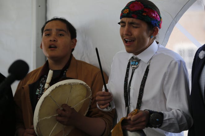 Navajo Preparatory School students Anthony Cruz, left, and Devin Lansing sing a social dance song in the Navajo language at the school's 30th anniversary on May 12 in Farmington.