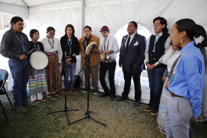 The Warrior Club at Navajo Preparatory School sing a social dance song in the Navajo language on May 12 at the school's 30th anniversary event in Farmington.