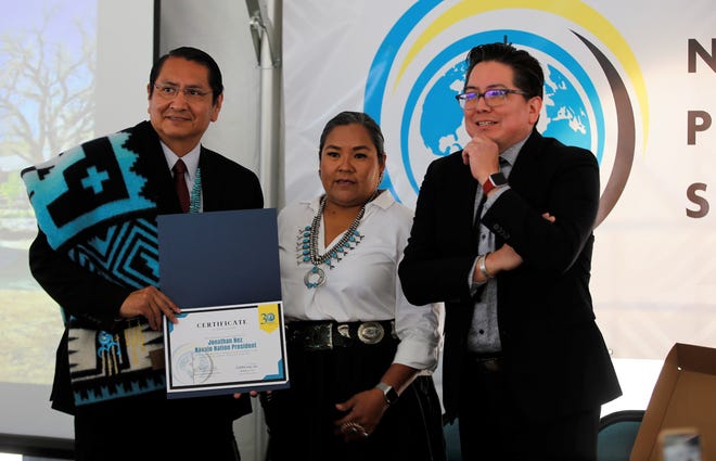 Navajo Nation President Jonathan Nez, left, was presented with a blanket and a certificate to mark the 30th anniversary of Navajo Preparatory School. The items were presented on May 12 by Shawna Becenti, the head of school, center, and Sherrick Roanhorse, board of trustees member.