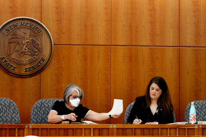New Mexico Gov. Michelle Lujan Grisham, left, and Secretary of State Maggie Toulouse Oliver certify results of the state's primary election on Tuesday, June, 28, 2022, at the state Capitol in Santa Fe. The June 7 primary was nearly derailed by county officials amid voter distrust fueled by unfounded voting machine conspiracies that have spread in the U.S. Toulouse Oliver says she wants to provide better access to accurate information about the election process.