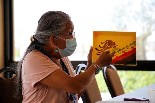Theresa Pablo talks about her painting on June 30 during the Celebration of Women Conference hosted by Sisters in Circle at the Farmington Civic Center.