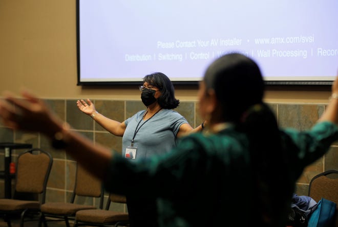 Regina BlueEyes teaches tai chi on June 30 during the Celebration of Women Conference hosted by Sisters in Circle at the Farmington Civic Center.