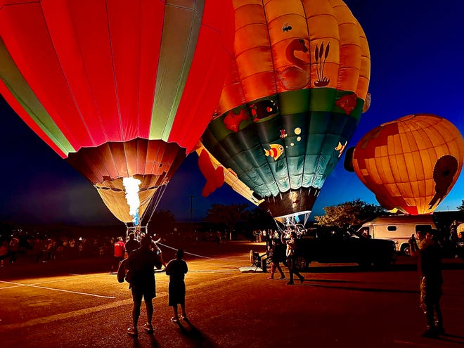 An appreciative crowd comes in for a closer look as hot air balloons glowed in front of the Henderson Fine Arts Center at the San Juan College campus Sept 23, part of the Four Corners Balloon Rally.
