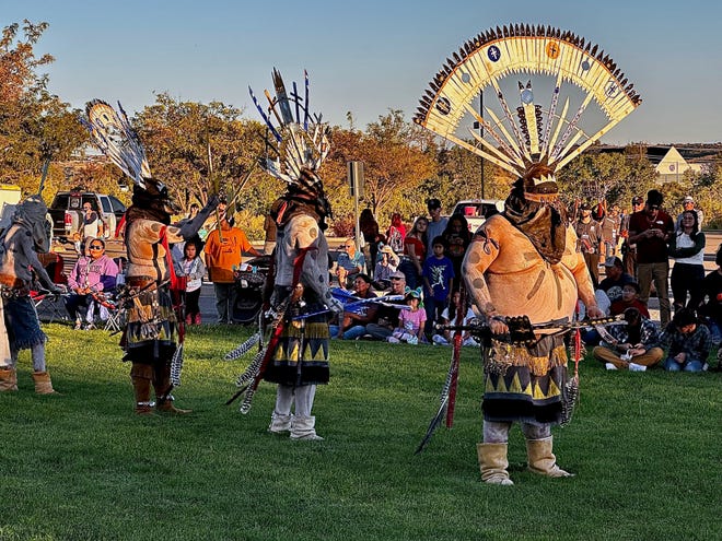 The setting sun cast a golden glow on a performance by the White Mountain Apache Dancers during a balloon glow event at San Juan College. The event Sept. 23 also included a roaming hypnotist, a balloon lady, and a performance by the college's African drumming group.