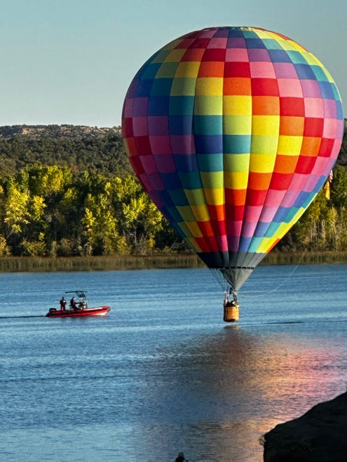 A safety vessel kept watch as balloon pilots departed above Lake Farmington on Sept. 24 as part of the Four Corners Balloon Rally.