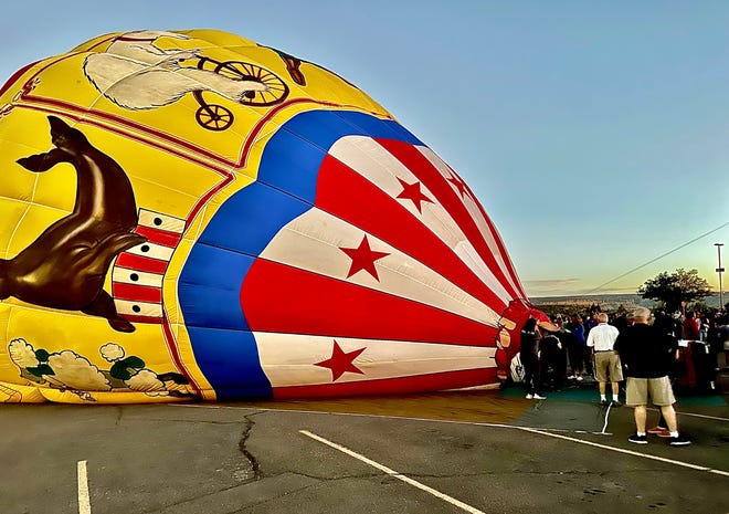 The process isn't quick, but a curious crowd drew around as hot air balloons began to inflate and the sun began to set on the San Juan College campus Sept. 23.