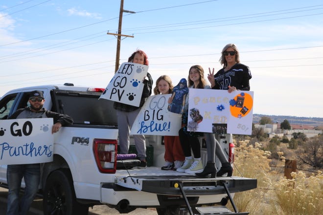 Parents and supporters line the road leaving Piedra Vista High School on Friday, Nov. 18, 2022 as the Panthers football team prepare for a long road trip to Roswell where they will face the Coyotes on Saturday at the Wool Bowl