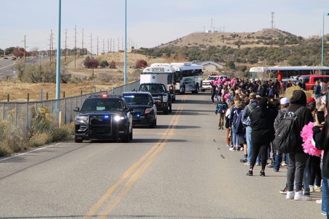 The Piedra Vista High School football team receives a police escort Friday, Nov. 18, 2022 as they prepare for a long road trip to Roswell and a Saturday Class 5A semifinal game against the Coyotes.